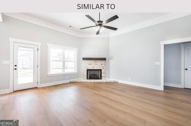 104 Reedy Ct, Perry, GA 31069 - unfurnished living room featuring light wood-style floors, crown molding, a ceiling fan, and a brick fireplace