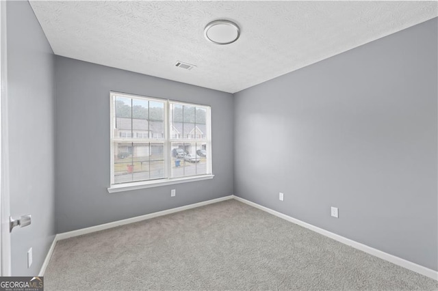 720 Georgetown Ln, Jonesboro, GA 30236 - carpeted spare room with a textured ceiling, baseboards, and visible vents