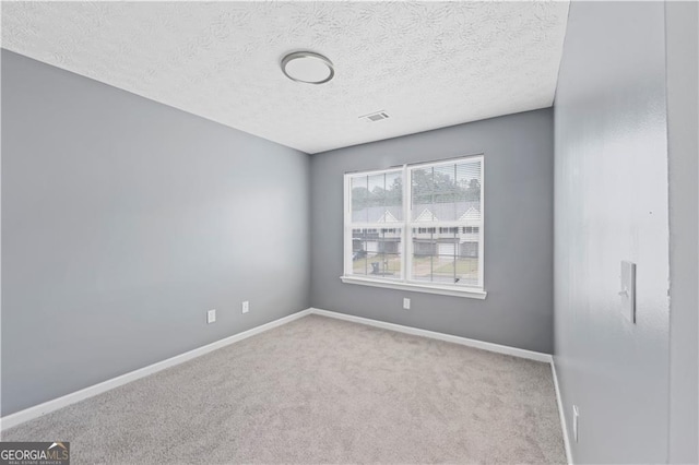 720 Georgetown Ln, Jonesboro, GA 30236 - carpeted spare room with a textured ceiling, visible vents, and baseboards