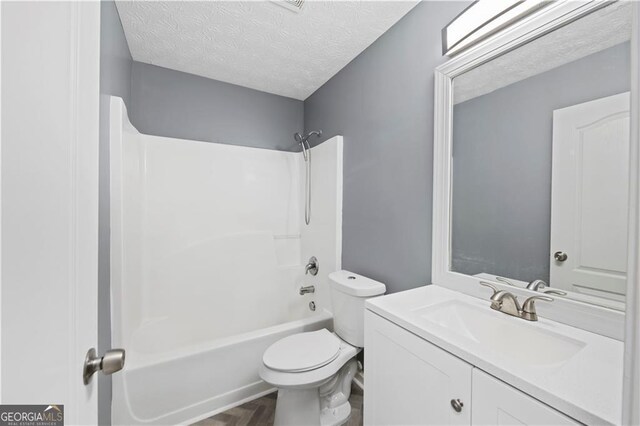 720 Georgetown Ln, Jonesboro, GA 30236 - full bath with shower / bath combination, a textured ceiling, toilet, and vanity