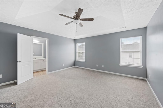720 Georgetown Ln, Jonesboro, GA 30236 - unfurnished bedroom with light colored carpet, multiple windows, a textured ceiling, and visible vents