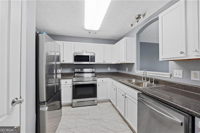 720 Georgetown Ln, Jonesboro, GA 30236 - kitchen with stainless steel appliances, marble finish floor, a sink, and dark countertops