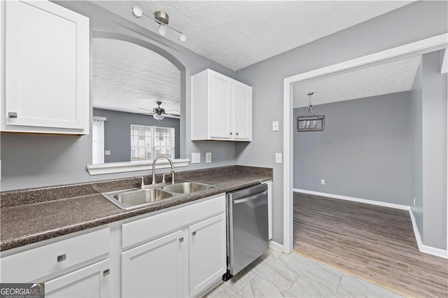 720 Georgetown Ln, Jonesboro, GA 30236 - kitchen featuring white cabinets, dark countertops, stainless steel dishwasher, a sink, and a textured ceiling