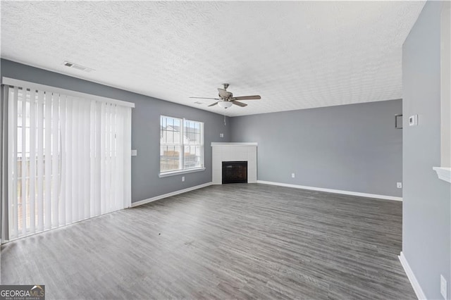 720 Georgetown Ln, Jonesboro, GA 30236 - unfurnished living room featuring a tile fireplace, wood finished floors, visible vents, baseboards, and ceiling fan