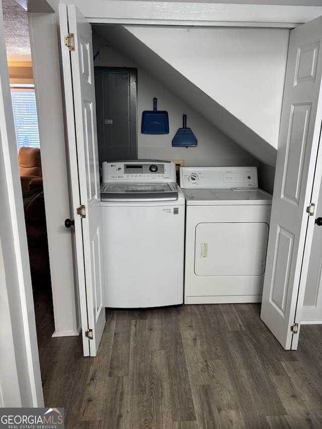 clothes washing area featuring separate washer and dryer, dark wood-style floors, and electric panel