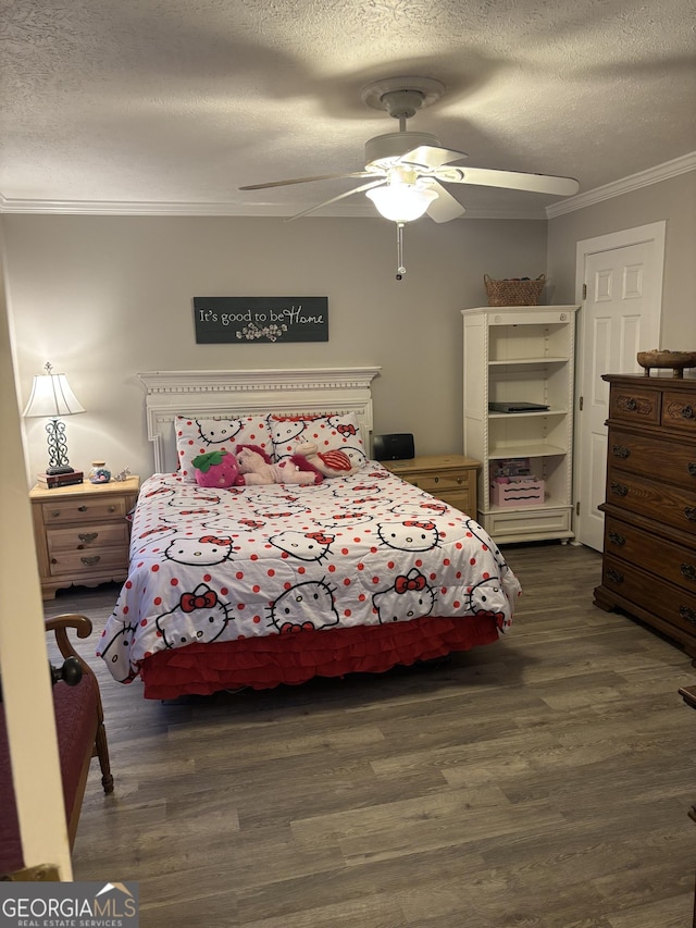 bedroom featuring a textured ceiling, ornamental molding, dark wood-style floors, and a ceiling fan