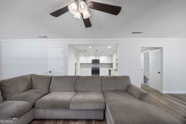 6101 River Rd Apt 20, Columbus, GA 31904 - living room with a ceiling fan, ornamental molding, wood finished floors, and visible vents