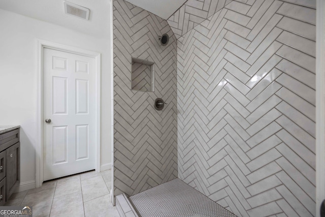 6101 River Rd Apt 20, Columbus, GA 31904 - full bath featuring vanity, tile patterned flooring, visible vents, and tiled shower