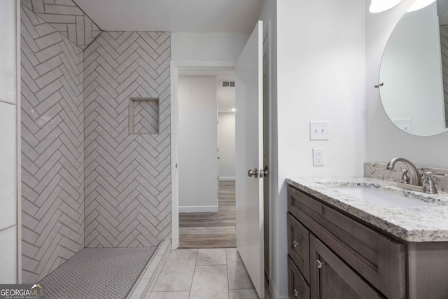 6101 River Rd Apt 20, Columbus, GA 31904 - full bath featuring a tile shower, baseboards, visible vents, tile patterned flooring, and vanity