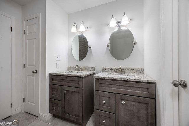 6101 River Rd Apt 20, Columbus, GA 31904 - bathroom featuring two vanities, tile patterned floors, baseboards, and a sink