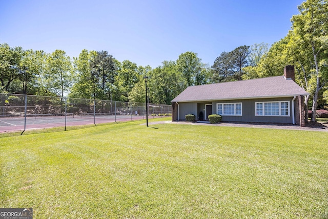 6101 River Rd Apt 20, Columbus, GA 31904 - view of front of property featuring a front yard, a tennis court, a chimney, and fence