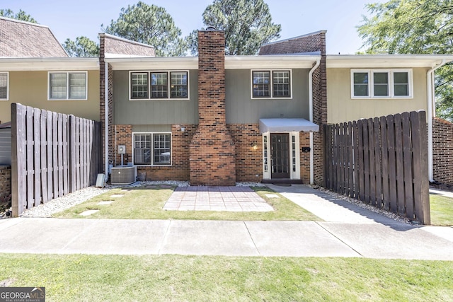 6101 River Rd Apt 20, Columbus, GA 31904 - view of front facade featuring brick siding, a patio area, a chimney, and fence