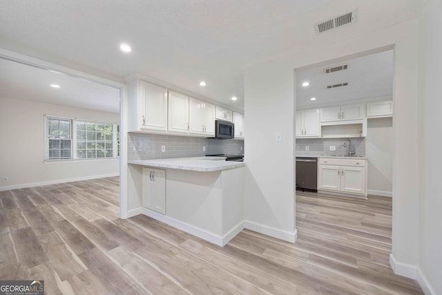 6101 River Rd Apt 20, Columbus, GA 31904 - kitchen featuring white cabinets, tasteful backsplash, visible vents, and stainless steel appliances
