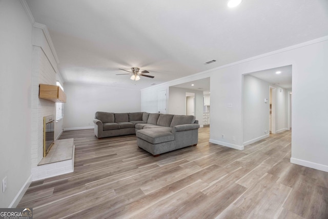 6101 River Rd Apt 20, Columbus, GA 31904 - living area with baseboards, visible vents, a ceiling fan, a brick fireplace, and ornamental molding