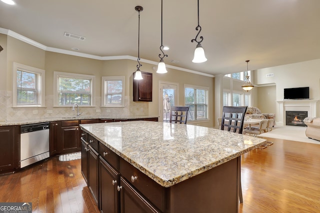 kitchen with dishwasher, a wealth of natural light, dark wood-style flooring, and visible vents