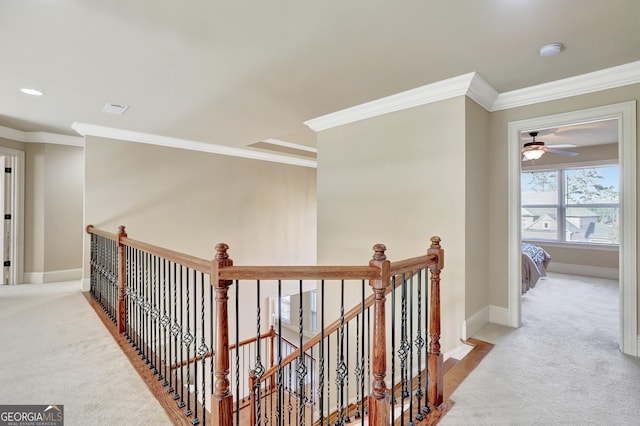 hallway featuring baseboards, crown molding, an upstairs landing, and carpet