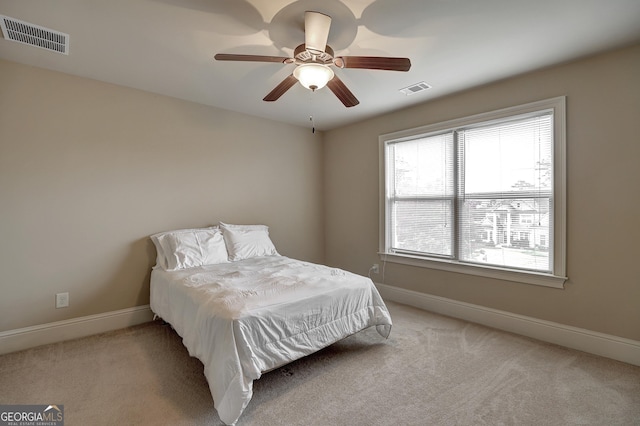 bedroom featuring carpet floors, visible vents, and baseboards