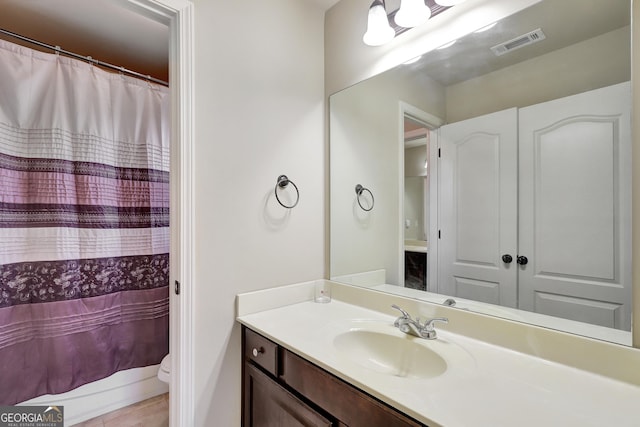 full bath with tile patterned floors, vanity, curtained shower, toilet, and visible vents