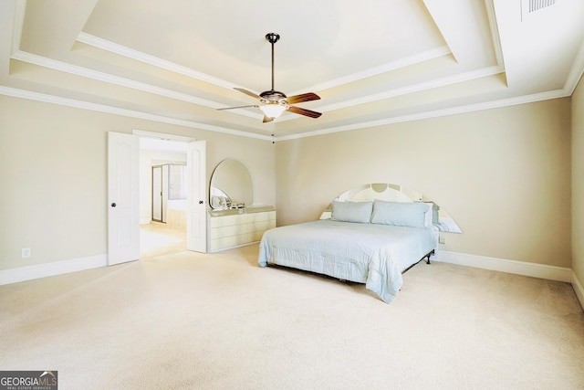 carpeted bedroom featuring a raised ceiling and ornamental molding