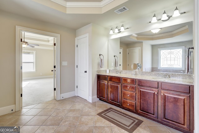 full bath featuring ornamental molding, a tray ceiling, and visible vents