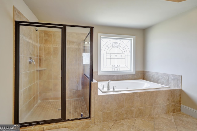 bathroom with tile patterned floors, a garden tub, and a stall shower