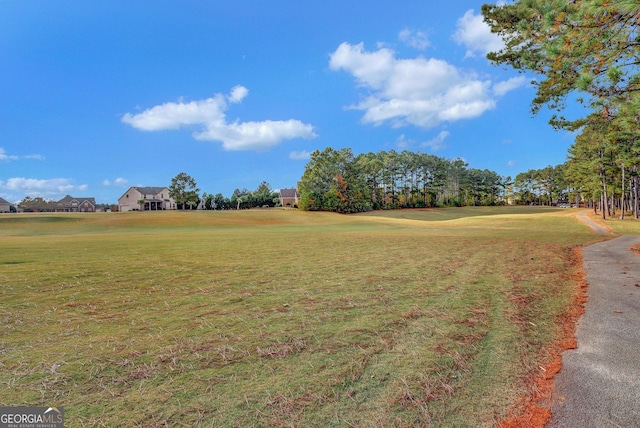 view of property's community featuring a lawn and golf course view