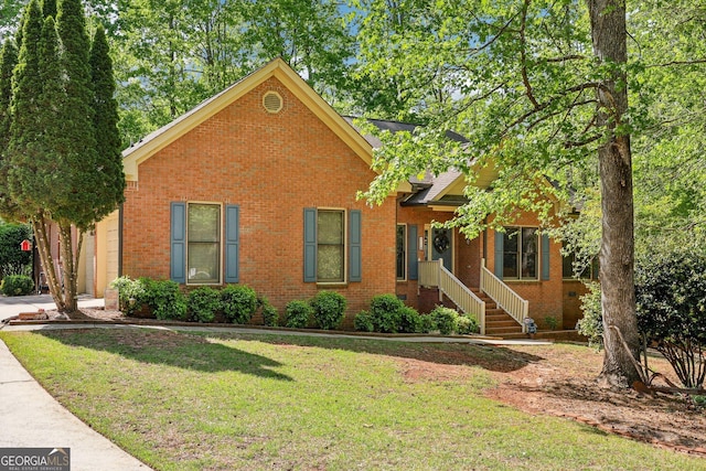 view of front of property with brick siding, concrete driveway, a front yard, and a garage