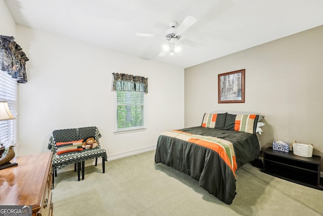 carpeted bedroom with baseboards and a ceiling fan