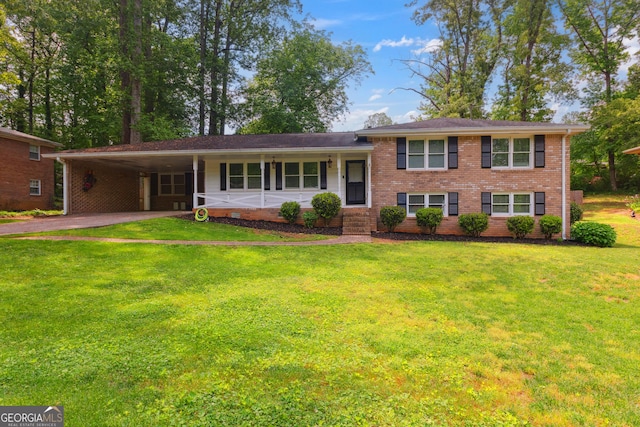tri-level home with brick siding, aphalt driveway, a front yard, and a carport