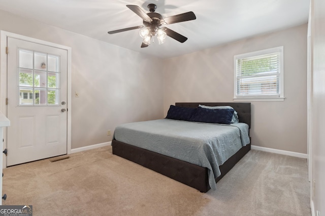 carpeted bedroom featuring baseboards, ceiling fan, and visible vents