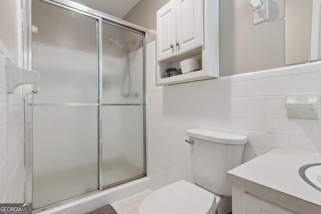 bathroom featuring toilet, tile walls, and a shower stall