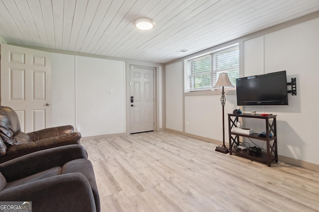 living room featuring baseboards, wooden ceiling, and light wood-style flooring