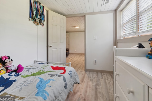 bedroom featuring visible vents, wooden ceiling, and light wood finished floors