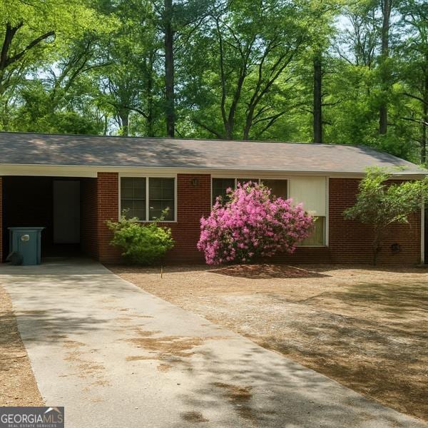 3272 Kingston Rd, Atlanta, GA 30318 - ranch-style house with concrete driveway, brick siding, and an attached carport