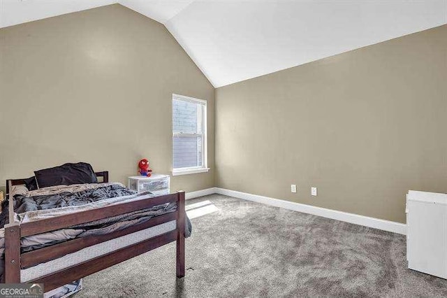 5015 Jack Dr, Decatur, GA 30035 - carpeted bedroom featuring vaulted ceiling and baseboards