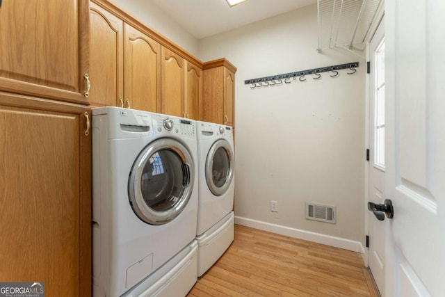160 Keese Ln, Fair Play, SC 29643 - laundry room featuring visible vents, washing machine and clothes dryer, baseboards, cabinet space, and light wood-style flooring