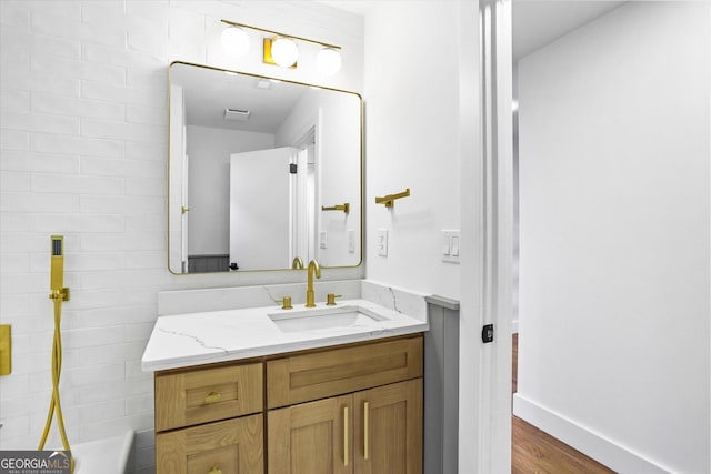 800 Kiowa Dr NE, Marietta, GA 30060 - bathroom featuring vanity, wood finished floors, a bath, and baseboards