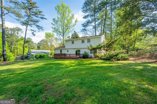4166 Rue Saint Michel, Stone Mountain, GA 30083 - rear view of house featuring a lawn and a wooden deck