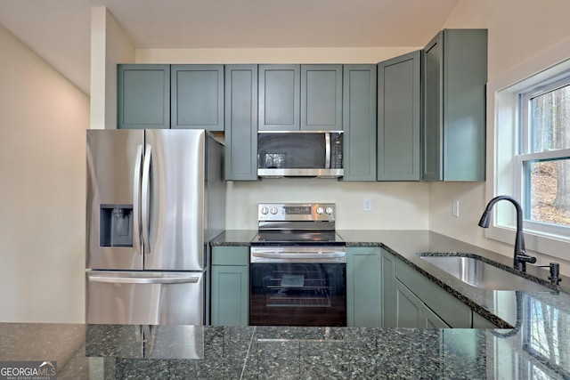 162 Forest Canopy Way, Clayton, GA 30525 - kitchen with dark stone counters, appliances with stainless steel finishes, and a sink