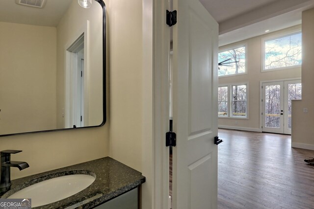 162 Forest Canopy Way, Clayton, GA 30525 - bathroom with baseboards, visible vents, wood finished floors, and vanity