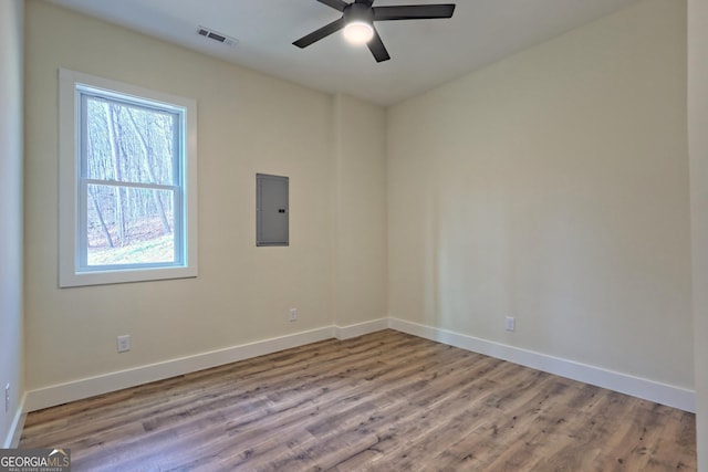 162 Forest Canopy Way, Clayton, GA 30525 - unfurnished room with visible vents, wood finished floors, baseboards, ceiling fan, and electric panel