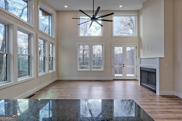 162 Forest Canopy Way, Clayton, GA 30525 - unfurnished living room with baseboards, plenty of natural light, and wood finished floors