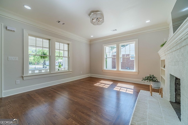 unfurnished living room featuring a healthy amount of sunlight, crown molding, baseboards, and built in features