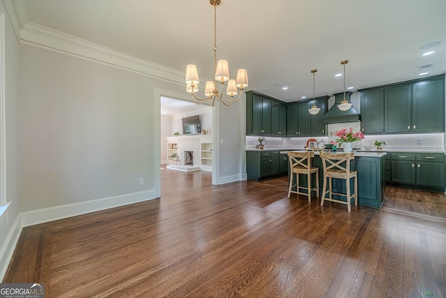 kitchen with a kitchen breakfast bar, light countertops, premium range hood, green cabinets, and a chandelier