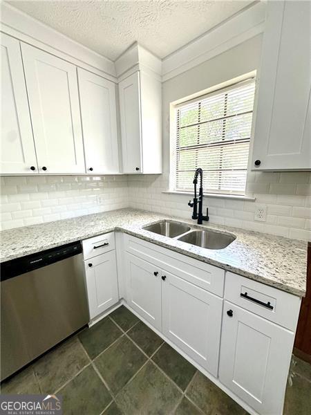 1836 Rainbow Ln, Powder Springs, GA 30127 - kitchen featuring dishwasher, decorative backsplash, and a sink