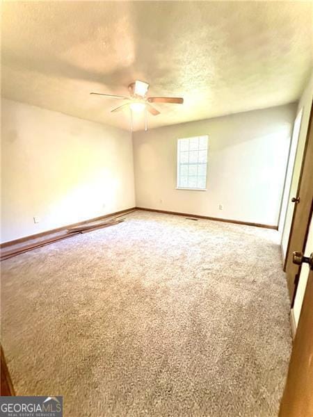 1836 Rainbow Ln, Powder Springs, GA 30127 - empty room with baseboards, carpet flooring, ceiling fan, and a textured ceiling
