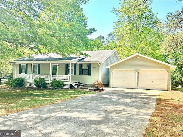 1836 Rainbow Ln, Powder Springs, GA 30127 - view of front of home featuring covered porch, an outbuilding, a front yard, and a detached garage