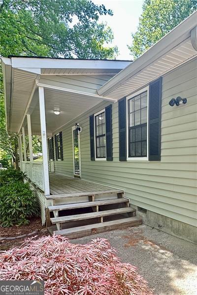 1836 Rainbow Ln, Powder Springs, GA 30127 - property entrance featuring covered porch