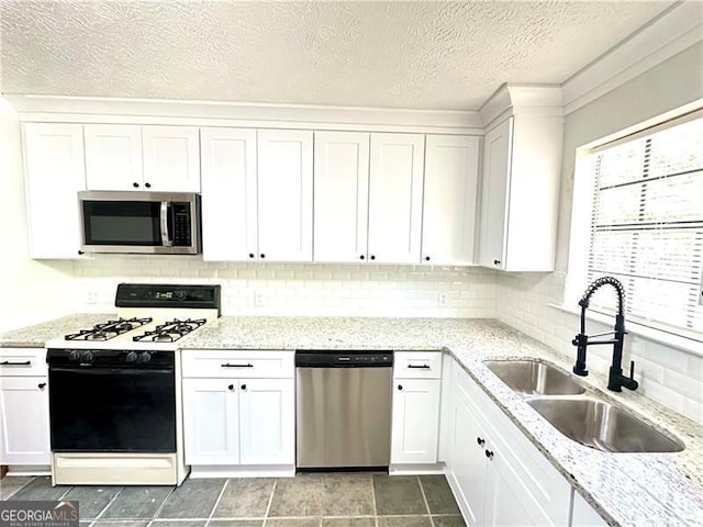 1836 Rainbow Ln, Powder Springs, GA 30127 - kitchen with a sink, white cabinetry, light stone countertops, appliances with stainless steel finishes, and tasteful backsplash