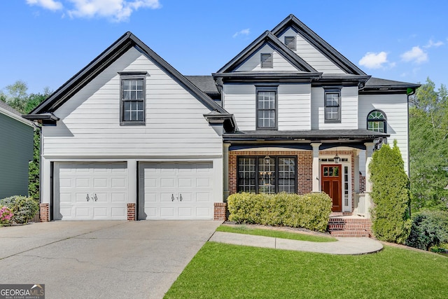 view of front of house featuring a front lawn, driveway, a garage, brick siding, and roof with shingles